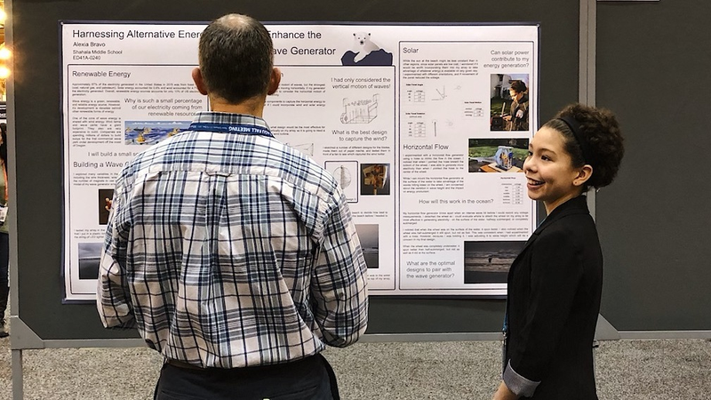 Alexia Bravo presenting her poster on small-scale renewable energy at AGU. Image: Brian Kahn